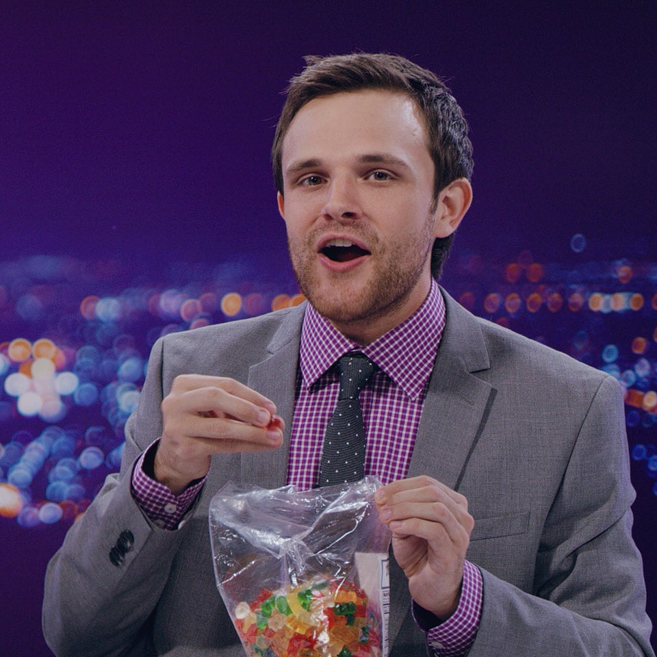 An actor eating gummy bears for a wireless company commercial