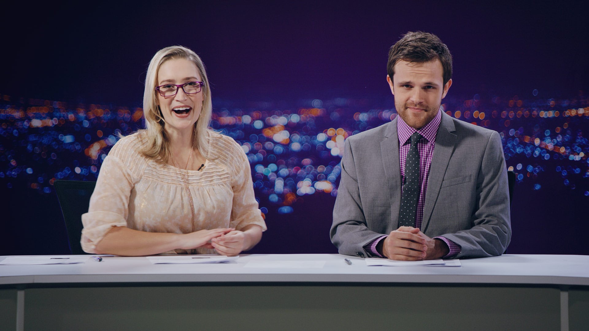 Actors playing news anchors for a wireless company commercial