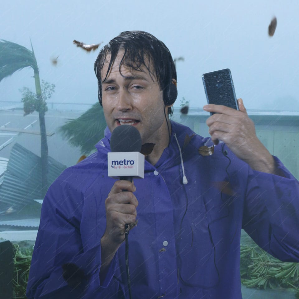 A green screen composite of a news anchor in a rain storm for a wireless company commercial