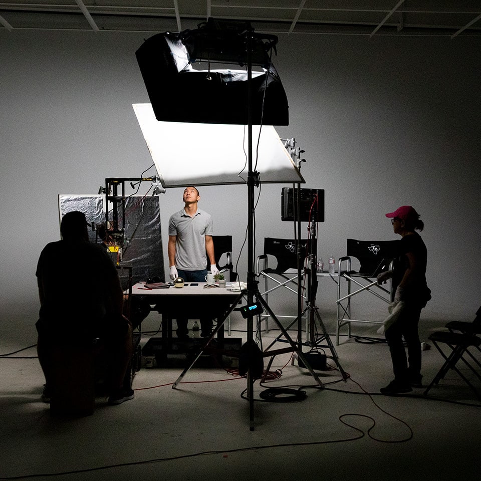 Lighting equipment being placed on a set for a product shoot