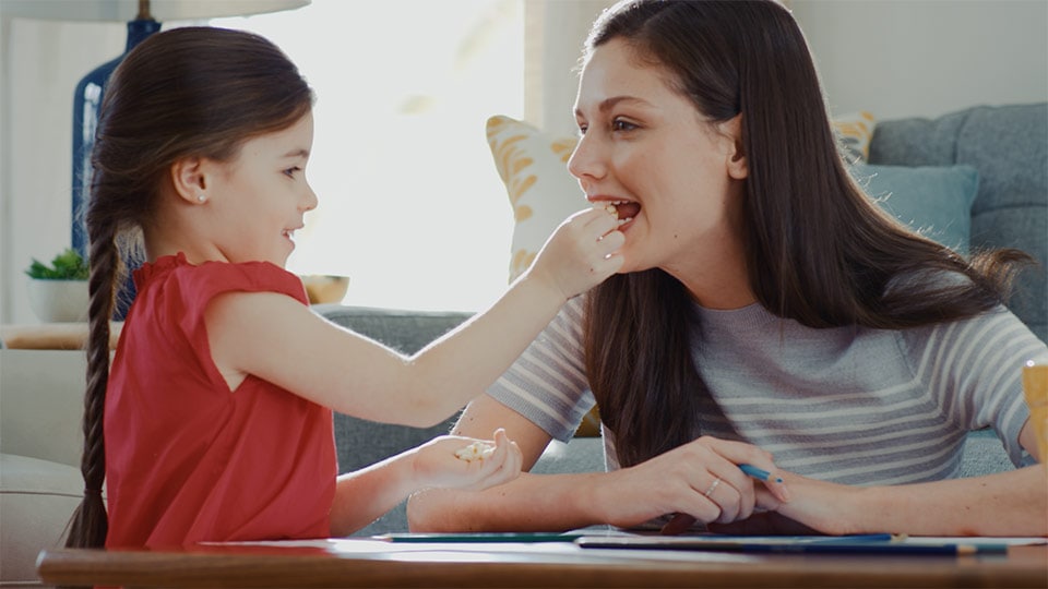 A color graded shot of a child and woman in a product demo commercial