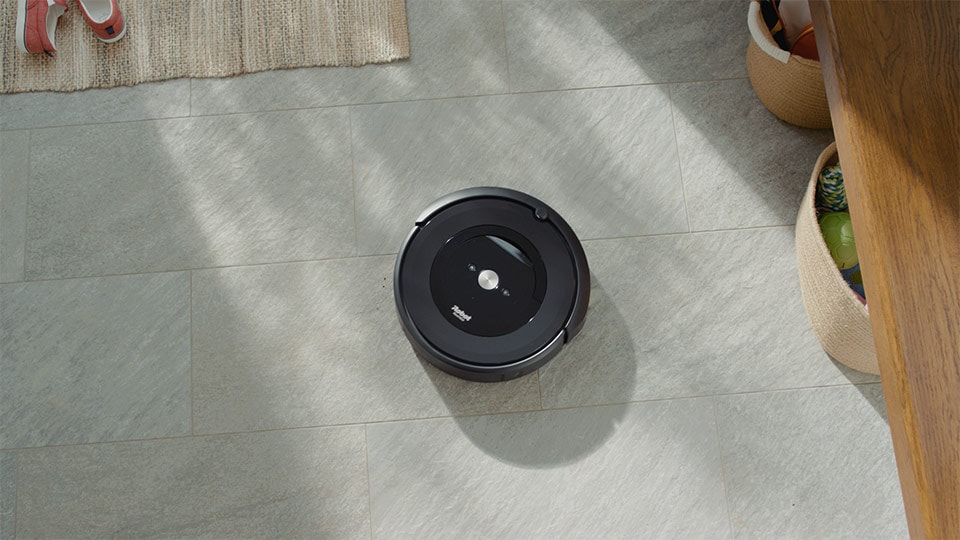 A color graded shot of a robot vacuum in a product demo commercial