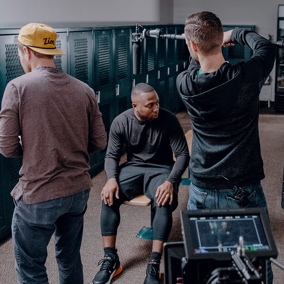 A sound engineer rigging an overhead mic for an interview