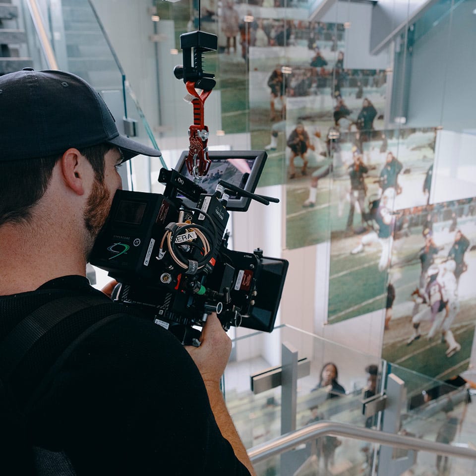 A camera operator holding a cinema camera