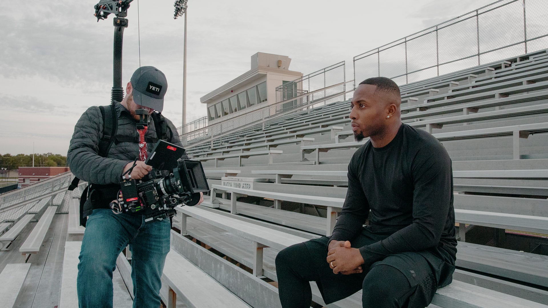 A camera operator filming a branded documentary video