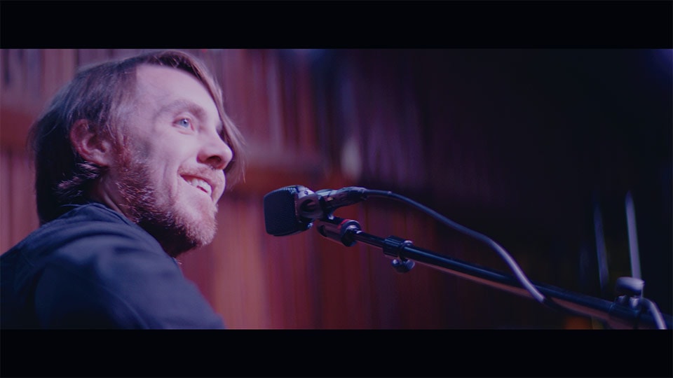 A musician performing in a branded documentary video